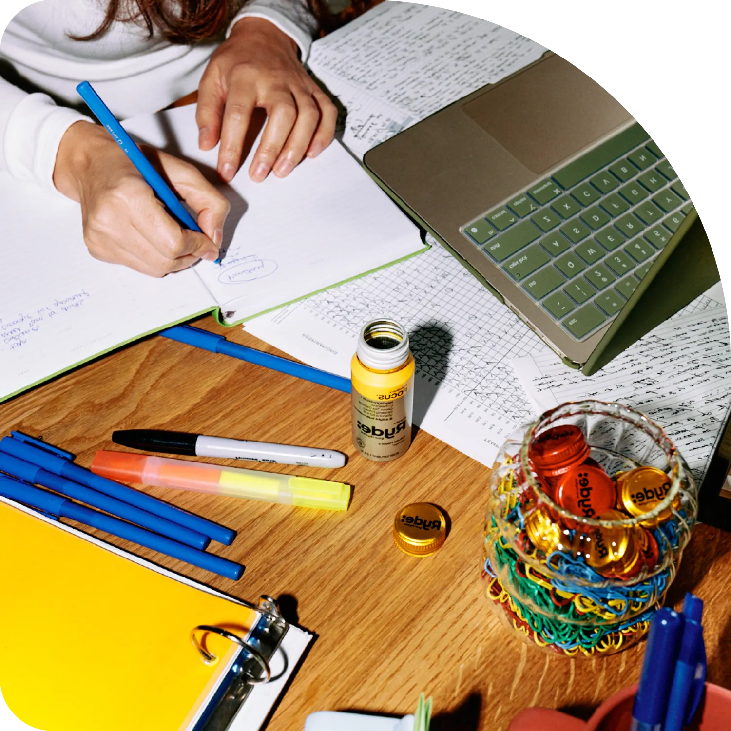 Notebook, laptop and a Ryde Focus shot on a wooden desk